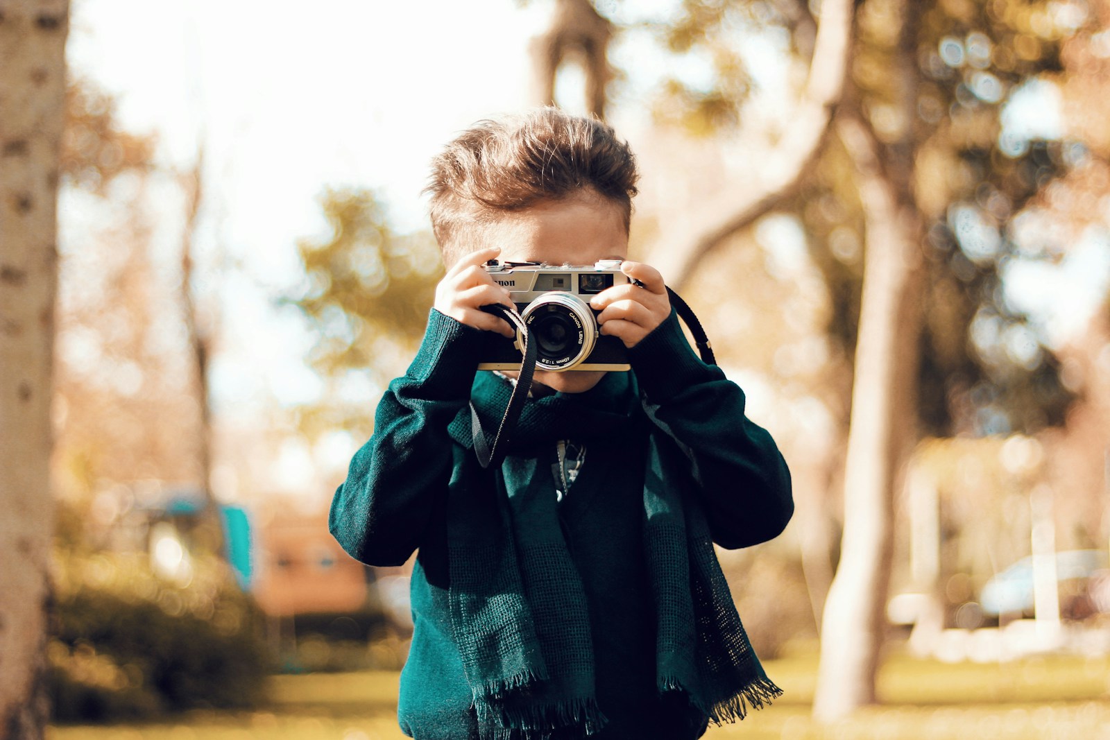 man in blue and black plaid long sleeve shirt holding camera